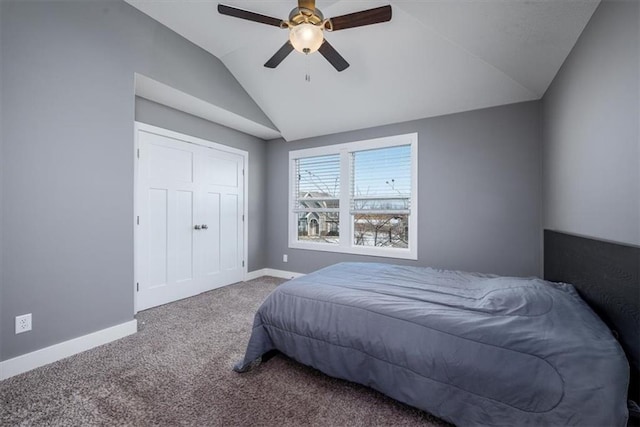 carpeted bedroom with ceiling fan and vaulted ceiling