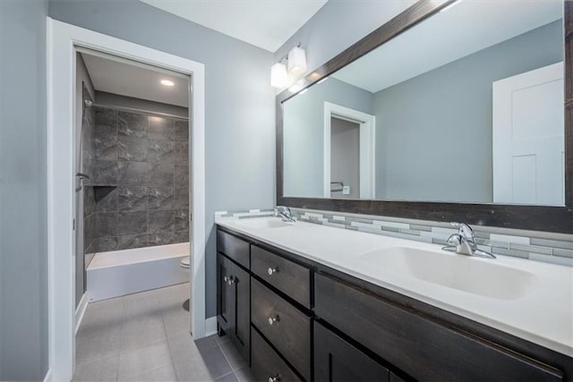 full bathroom with toilet, decorative backsplash, tiled shower / bath, tile patterned flooring, and vanity