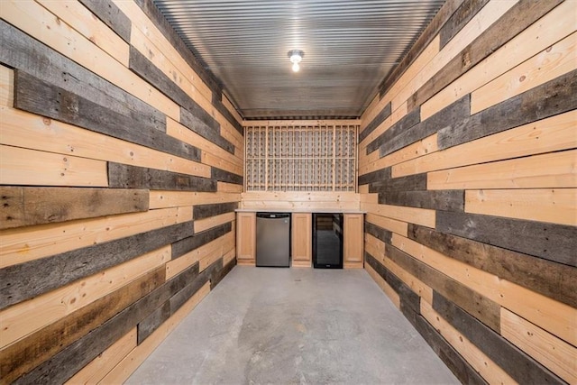 wine room with beverage cooler and concrete flooring