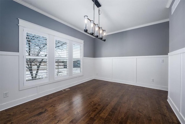 unfurnished dining area with a chandelier, crown molding, and dark hardwood / wood-style flooring