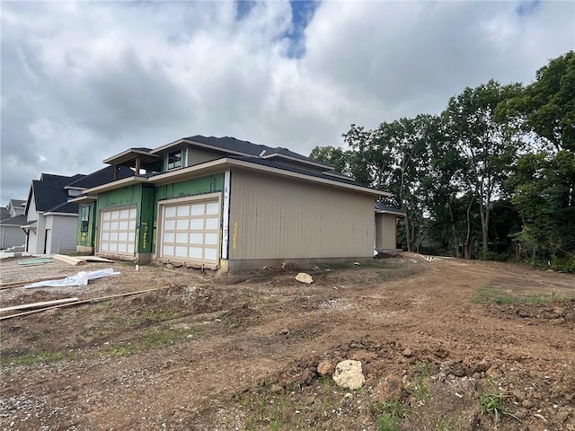 16900 Parkhill St, Overland Park, KS 66221 - view of property exterior with a garage and driveway