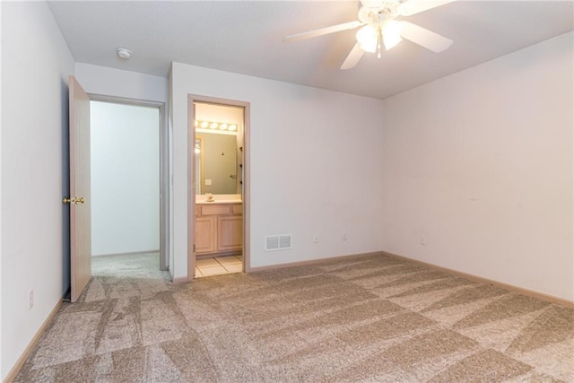 carpeted spare room featuring ceiling fan