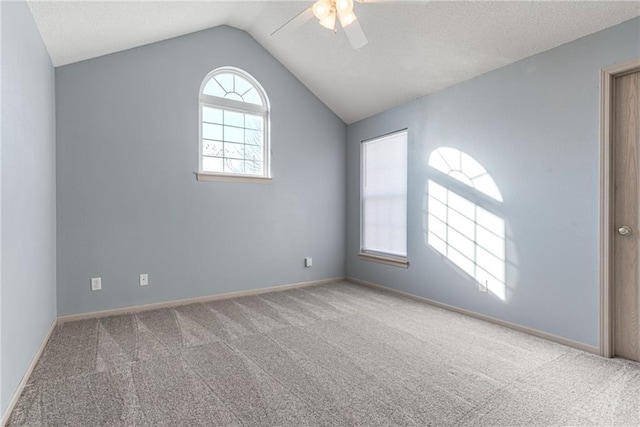 carpeted empty room featuring lofted ceiling and ceiling fan