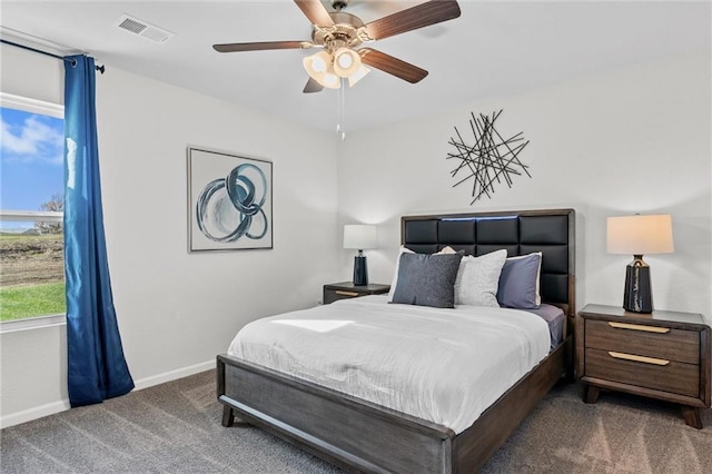 bedroom featuring ceiling fan and dark carpet