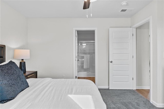 carpeted bedroom featuring ceiling fan and ensuite bath