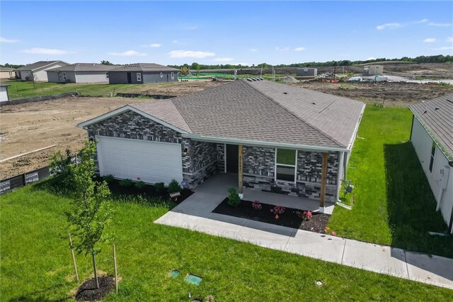 37887 W 207th Ter, Edgerton, KS 66021 - ranch-style home with an attached garage, a front yard, and covered porch