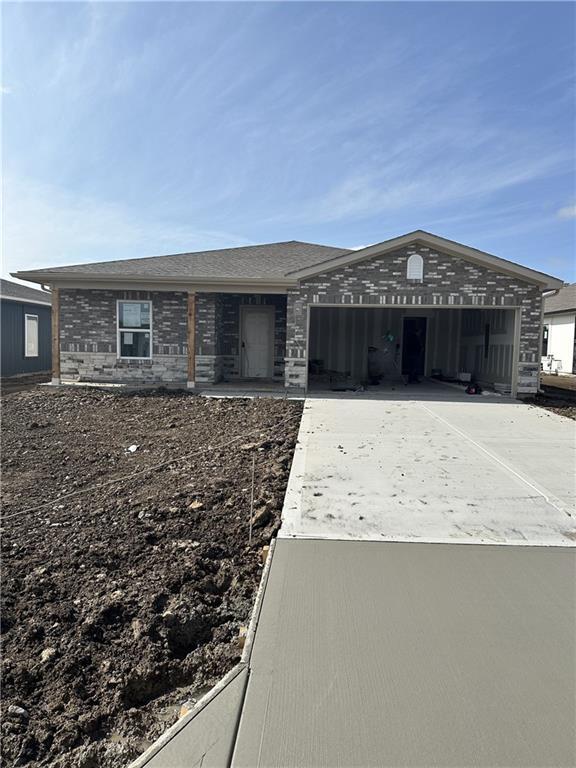 view of front of house with brick siding, concrete driveway, and an attached garage