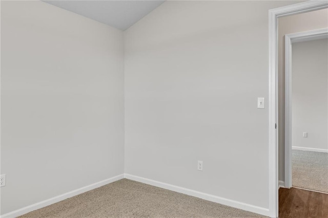 unfurnished room featuring baseboards and carpet