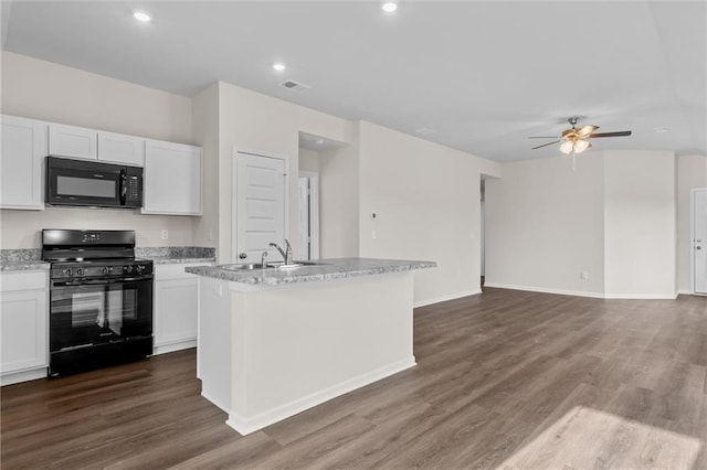 kitchen featuring an island with sink, ceiling fan, black appliances, white cabinets, and sink