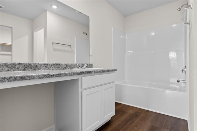 bathroom featuring bathtub / shower combination, wood-type flooring, and vanity