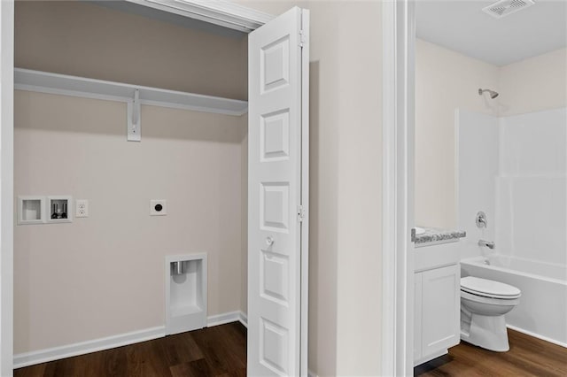 clothes washing area featuring dark wood-type flooring, washer hookup, and electric dryer hookup