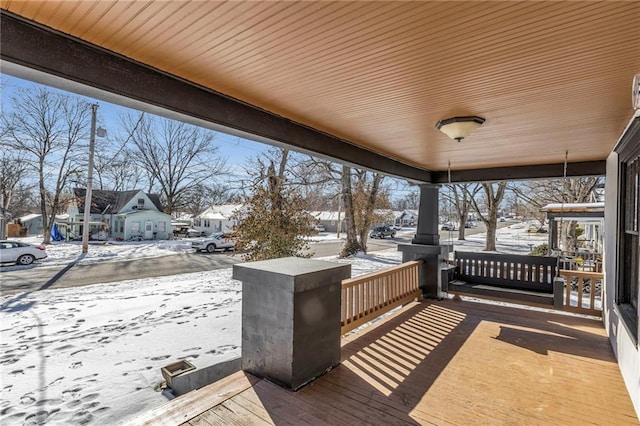 snow covered deck with covered porch