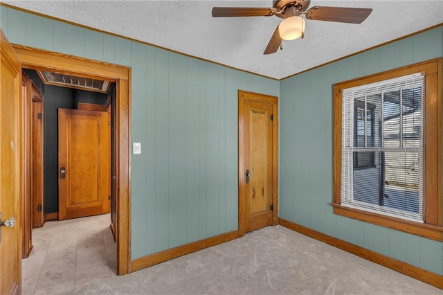 unfurnished bedroom with ceiling fan and ornamental molding