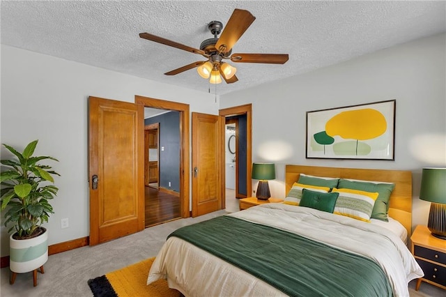 carpeted bedroom with ceiling fan and a textured ceiling