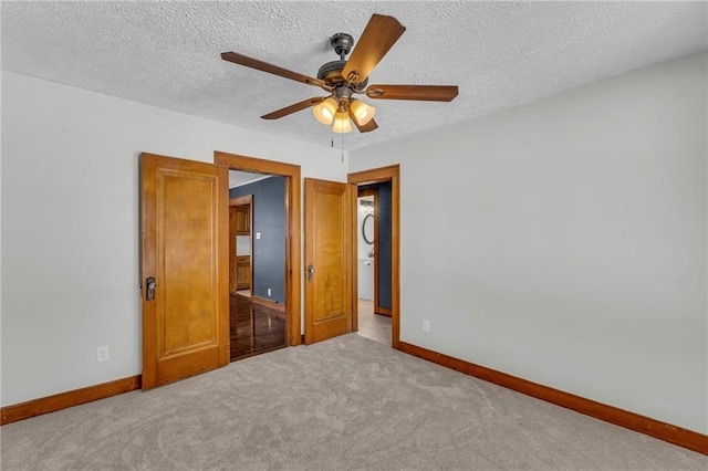 unfurnished bedroom with ceiling fan, a textured ceiling, and carpet floors