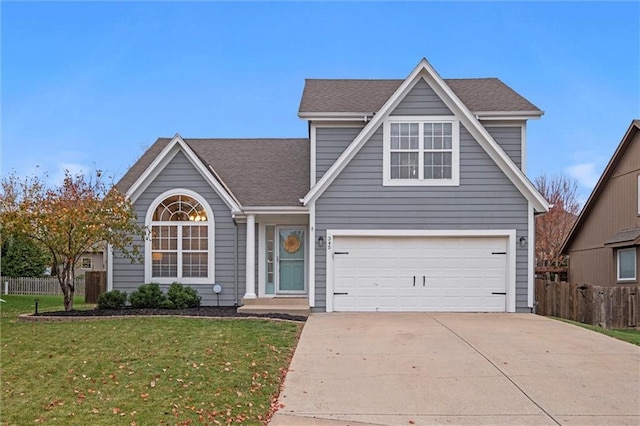 view of front of home featuring a front yard and a garage