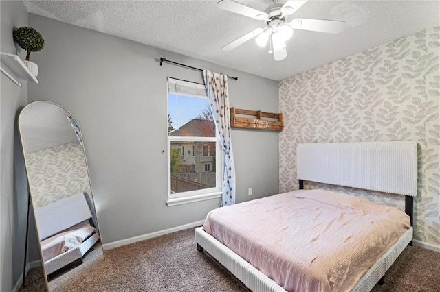 carpeted bedroom with ceiling fan and a textured ceiling