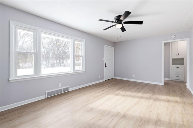 unfurnished bedroom with ceiling fan and light wood-type flooring