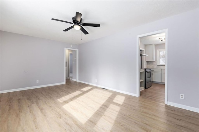 unfurnished room with ceiling fan and light hardwood / wood-style floors