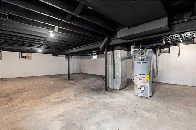 basement featuring heating unit and water heater