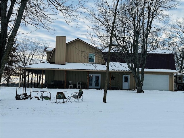 snow covered house featuring french doors