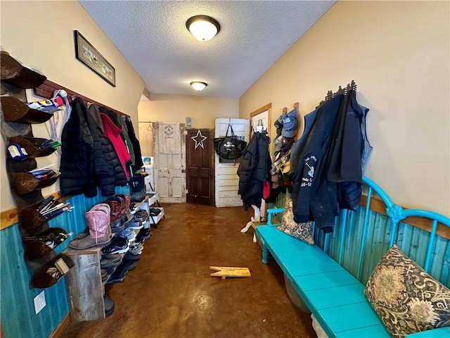 mudroom with a textured ceiling