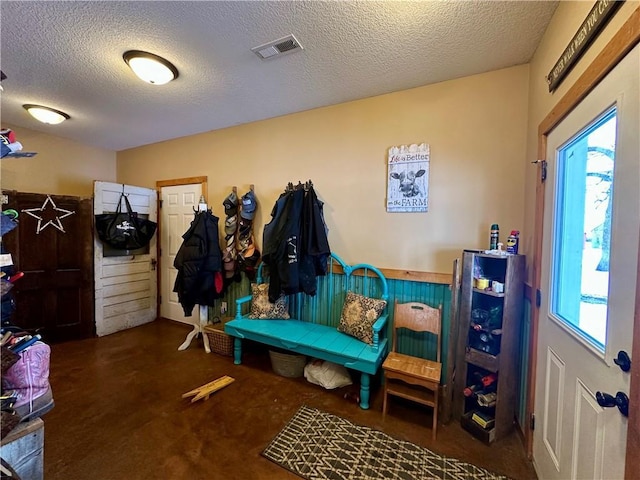 mudroom featuring a textured ceiling