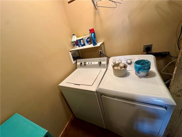 clothes washing area with washing machine and dryer