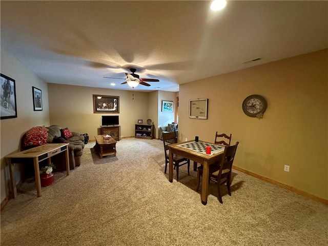 dining space with carpet floors and ceiling fan