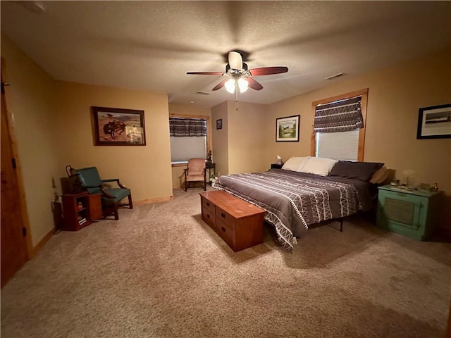 bedroom featuring a textured ceiling, ceiling fan, and light colored carpet