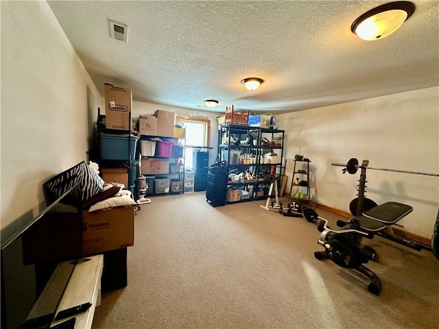 workout room featuring a textured ceiling