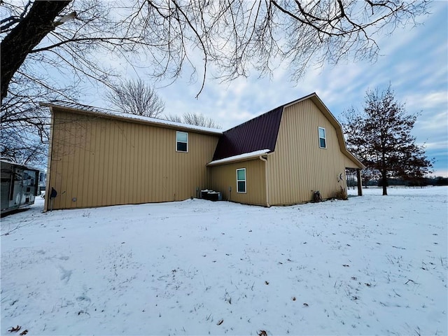 view of snow covered rear of property