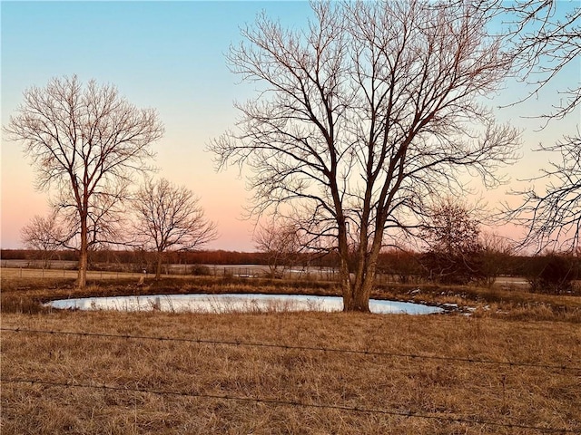 yard at dusk with a water view