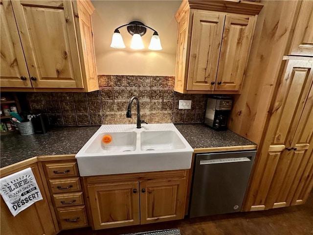 kitchen with stainless steel dishwasher, sink, and decorative backsplash