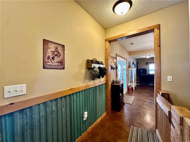 hallway with a textured ceiling