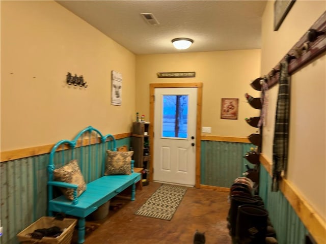 entryway with a textured ceiling