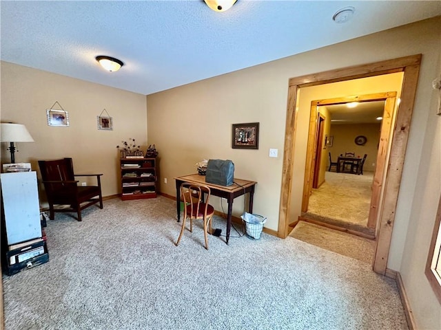 carpeted office with a textured ceiling