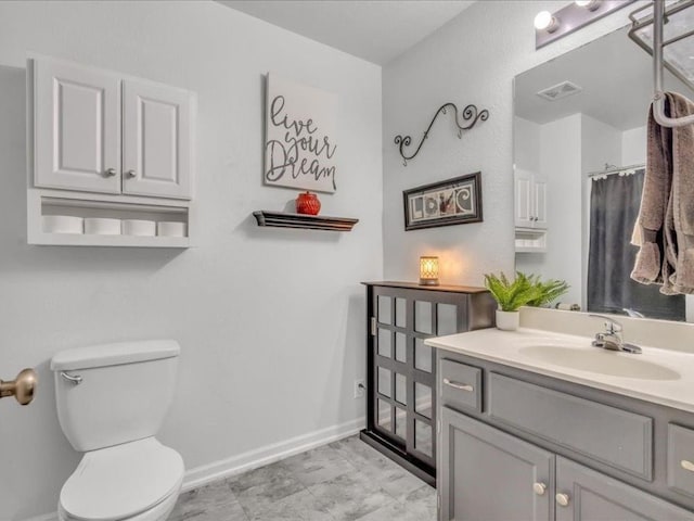 bathroom featuring toilet and vanity