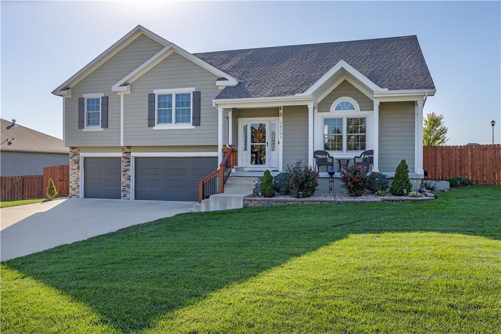 view of front of home with a garage and a front lawn