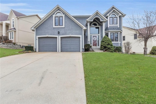 view of front of property featuring a front yard and a garage