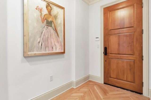 doorway to outside featuring light parquet flooring and ornamental molding