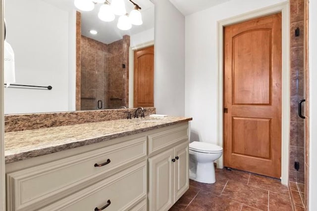 bathroom featuring toilet, vanity, and walk in shower