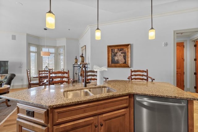 kitchen with dishwasher, decorative light fixtures, a center island with sink, and ornamental molding