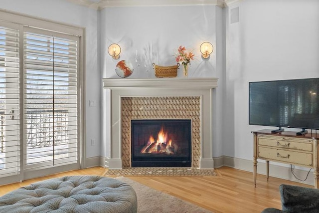 interior space with light hardwood / wood-style floors and a tiled fireplace