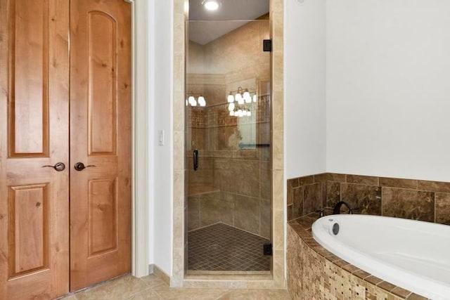 bathroom featuring tile patterned flooring and shower with separate bathtub