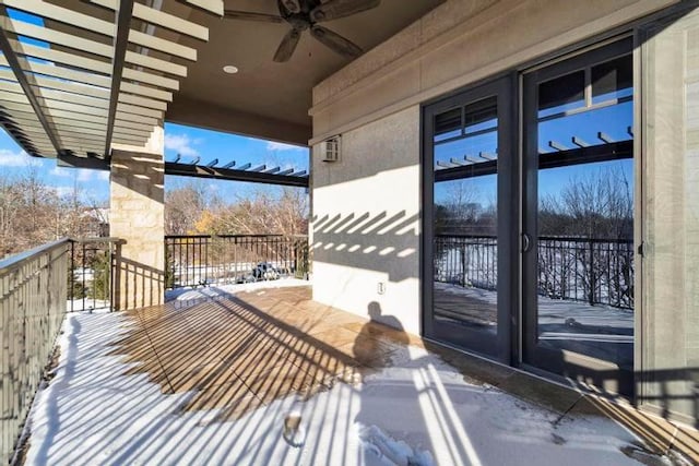 snow covered back of property with ceiling fan