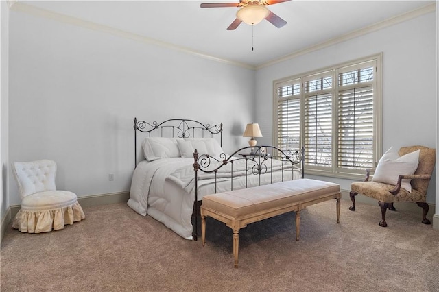 carpeted bedroom with ceiling fan and ornamental molding