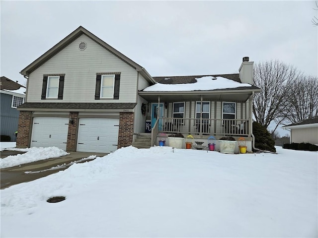 split level home featuring a porch and a garage