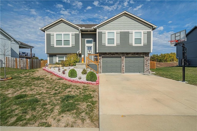 bi-level home featuring a front yard and a garage