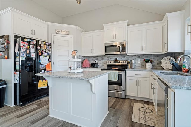 kitchen with white cabinets, sink, a kitchen island, and appliances with stainless steel finishes